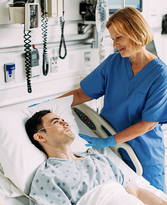 Nurse at bedside with patient